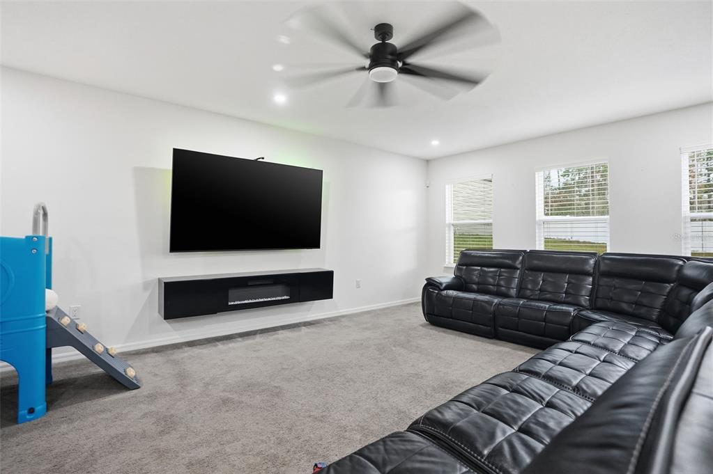 13286 Pendleton Street Spring Hill, FL 34609 - Photo 23 of 57 a living room with furniture and a flat screen tv