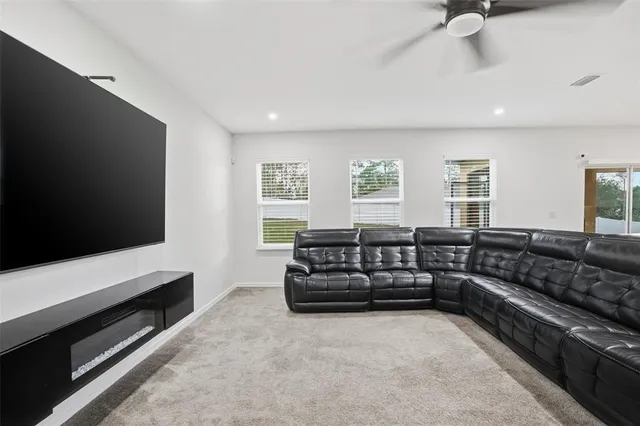 a bedroom with a large bed and a ceiling fan