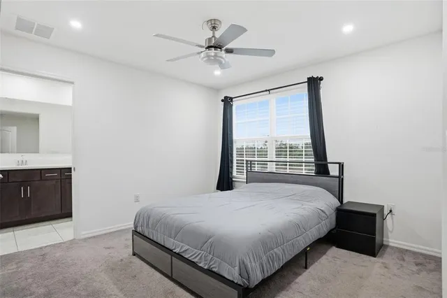 a bathroom with a granite countertop sink mirror vanity and toilet