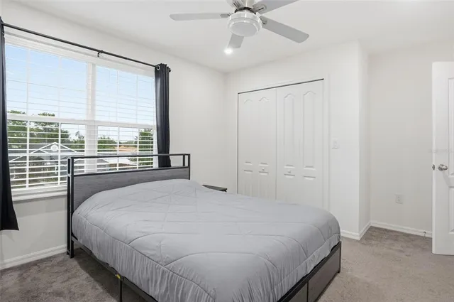 a white toilet sitting next to a white wall