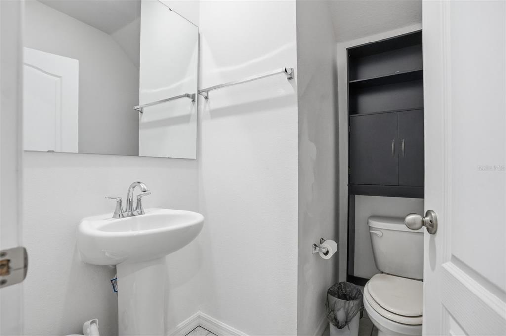 13286 Pendleton Street Spring Hill, FL 34609 - Photo 43 of 57 a bathroom with a sink toilet and a mirror