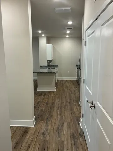 a view of a living room with wooden floor