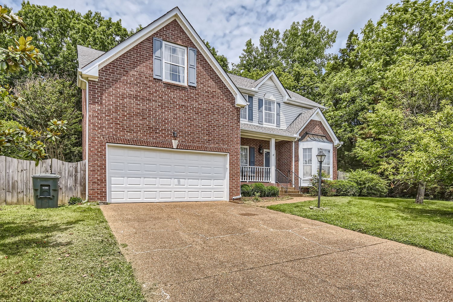 5244 Beech Ridge Road Nashville, TN 37221 - Photo 2 of 31 a front view of a house with a yard and garage