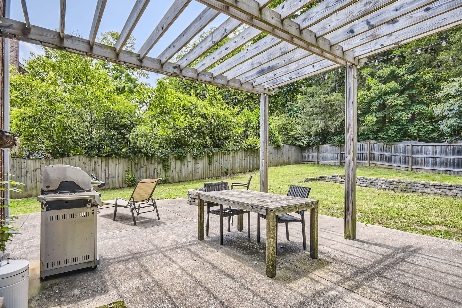 5244 Beech Ridge Road Nashville, TN 37221 - Photo 25 of 31 a view of a patio with a table chairs and a backyard