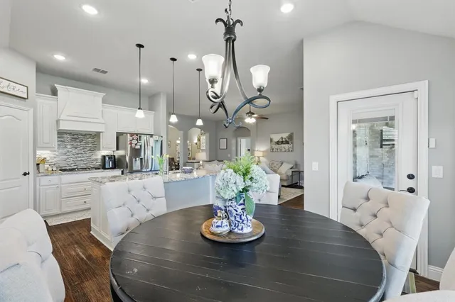 a kitchen with a table and a chandelier