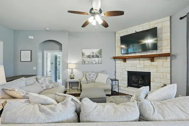 a living room with furniture and a fireplace