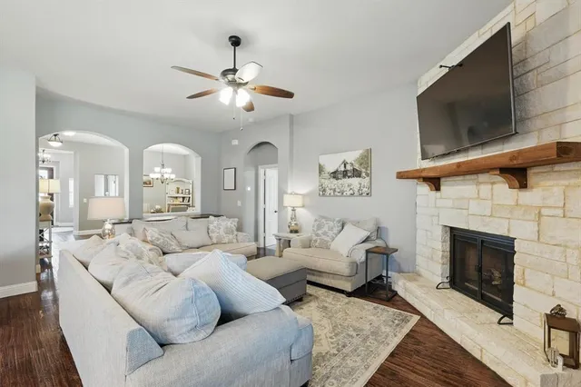 a living room with furniture a flat screen tv and a fireplace
