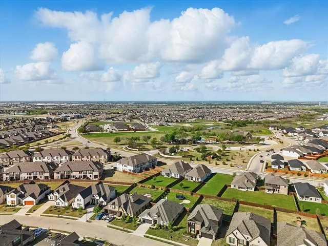 an aerial view of residential building with yard