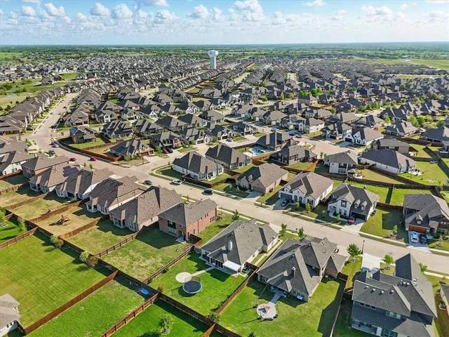 an aerial view of residential houses with outdoor space