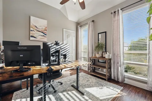 a view of a workspace with furniture and a window