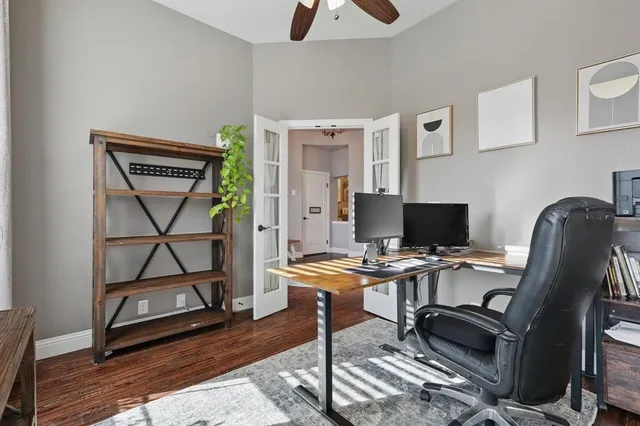 a view of a workspace with furniture and a window