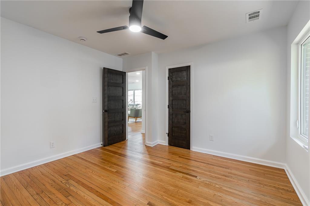 2651 Pangborn Road Decatur, GA 30033 - Photo 20 of 31 an empty room with wooden floor and chandelier fan