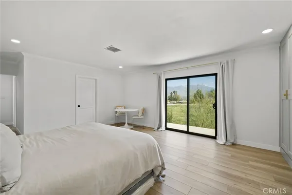 a spacious bedroom with a bed and a large window