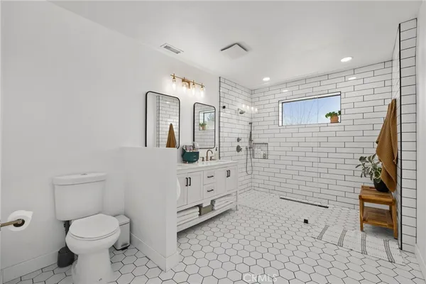 a bathroom with a toilet sink and shower