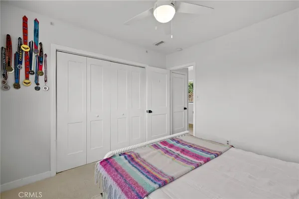 a bedroom with a bed and a book shelf