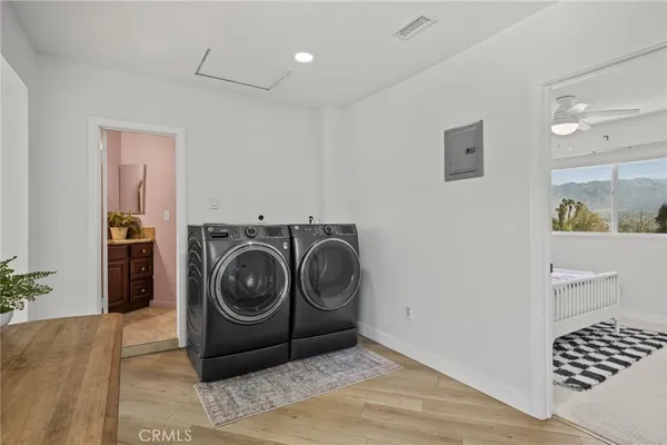 a view of a storage & utility room with a washer dryer