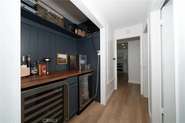 a hallway with a large mirror on a dresser