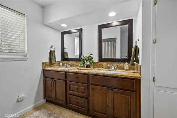 a bathroom with a double vanity sink and a mirror