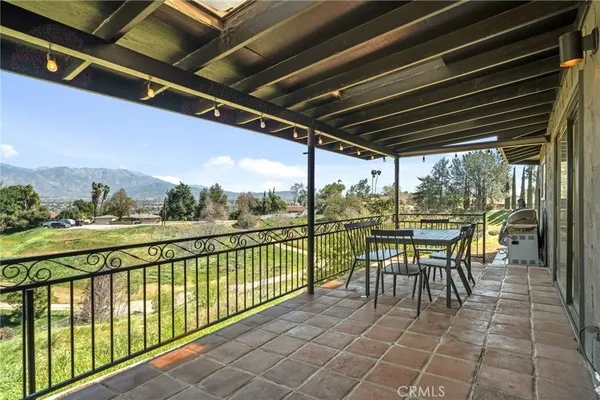 a view of a chairs and table in the balcony