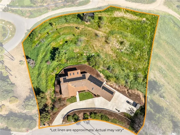 an aerial view of residential house with an outdoor space and mountain view