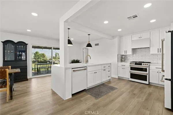 a kitchen with stainless steel appliances a stove and a refrigerator