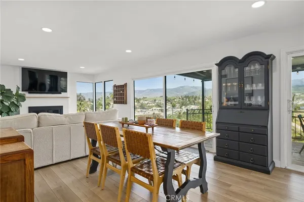 a dining room with furniture window and wooden floor