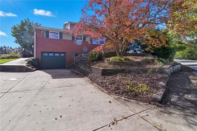 a pathway of a house with a yard