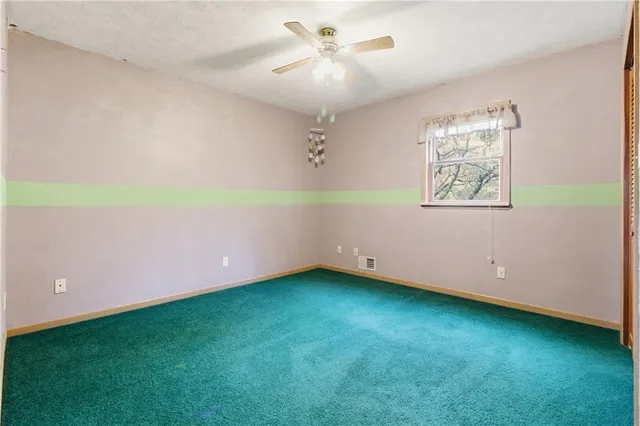 a bathroom with a sink a toilet and a window