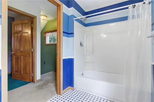 a view of an empty room with a fireplace and a window