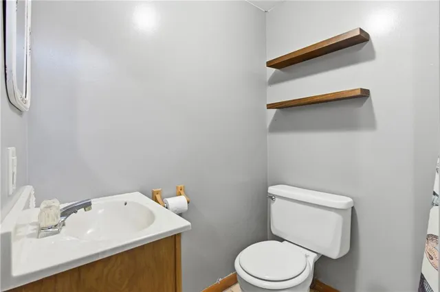 a kitchen with stainless steel appliances a stove top oven a sink a counter top space and cabinets