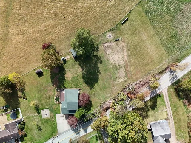 an aerial view of a house with a yard and plants