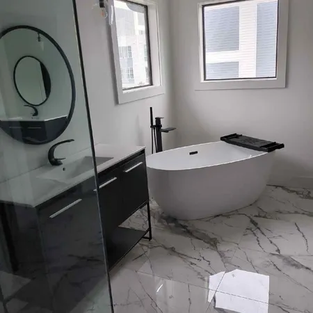 a bath room with a toilet a sink and a mirror