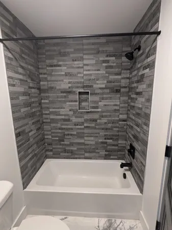 a bathroom with a shower and a toilet