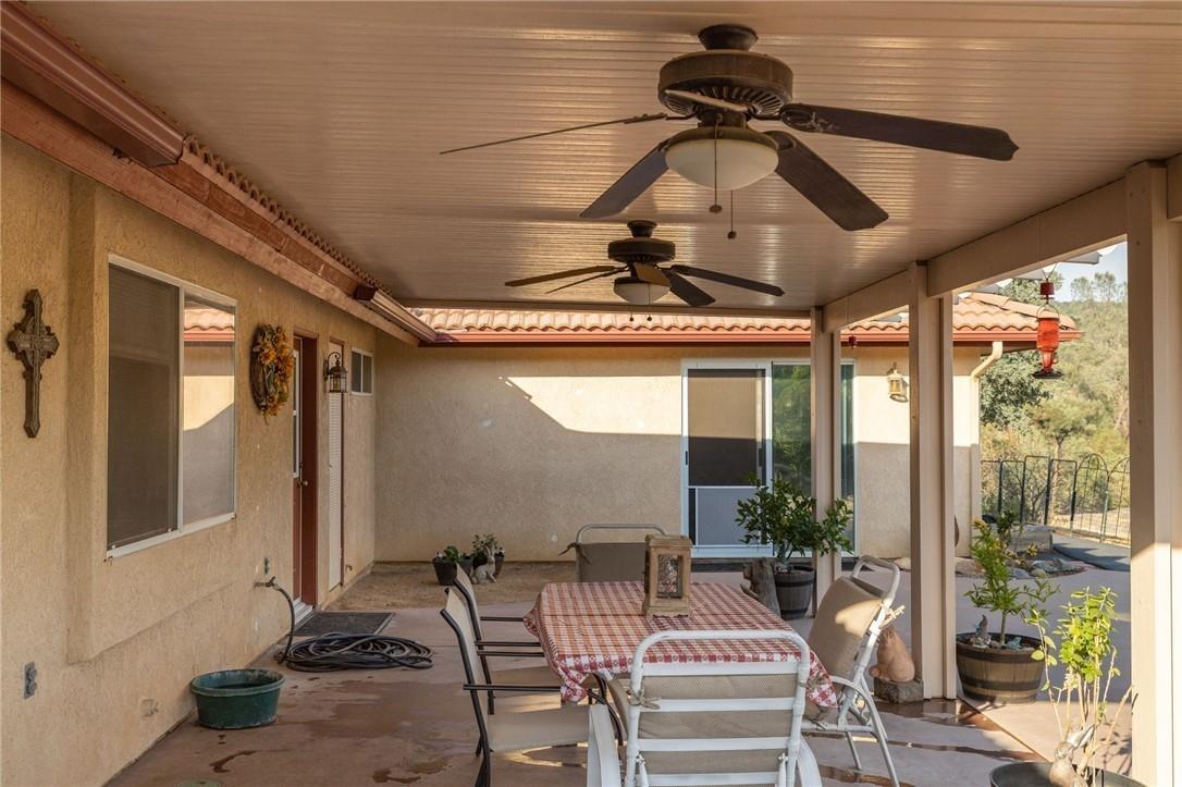 32057 River Knolls Road Coarsegold, CA 93614 - Photo 11 of 73 a view of a patio with a table and chairs