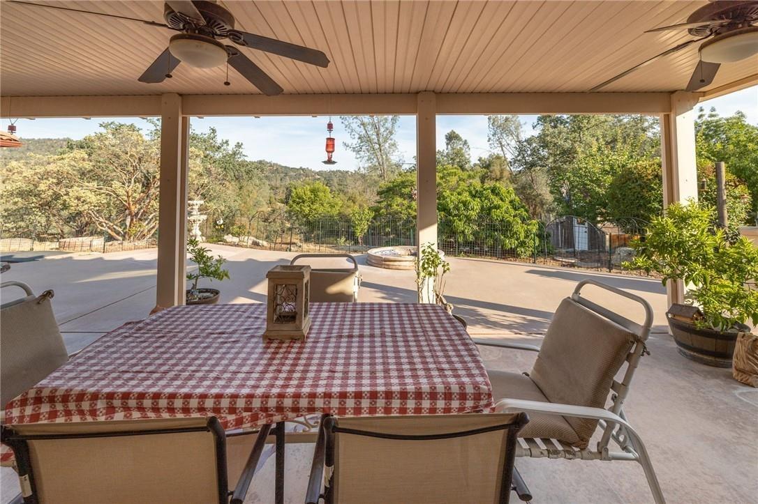 32057 River Knolls Road Coarsegold, CA 93614 - Photo 12 of 73 a view of a dining room with furniture window and outside view