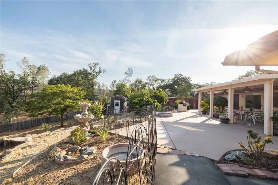 32057 River Knolls Road Coarsegold, CA 93614 - Photo 19 of 73 a view of a patio with couches table and chairs and potted plants