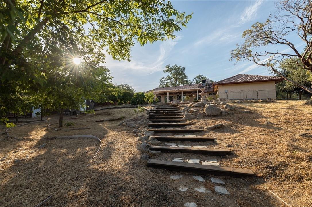 32057 River Knolls Road Coarsegold, CA 93614 - Photo 24 of 73 a view of a yard with wooden fence