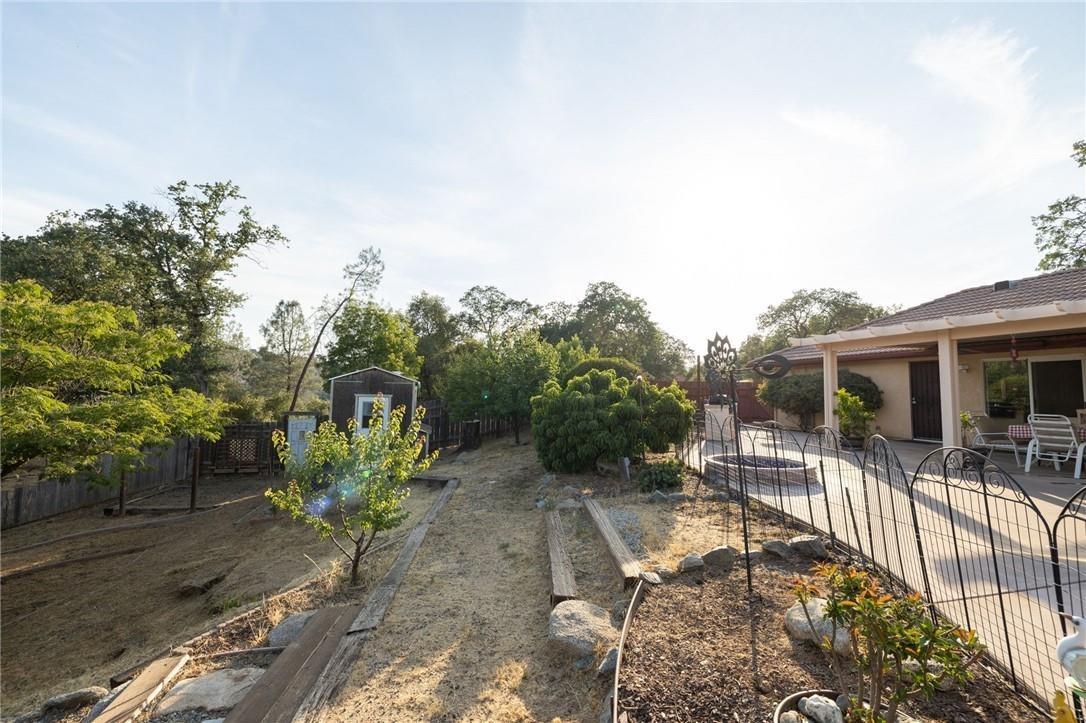 32057 River Knolls Road Coarsegold, CA 93614 - Photo 28 of 73 a view of a chair and tables on the patio