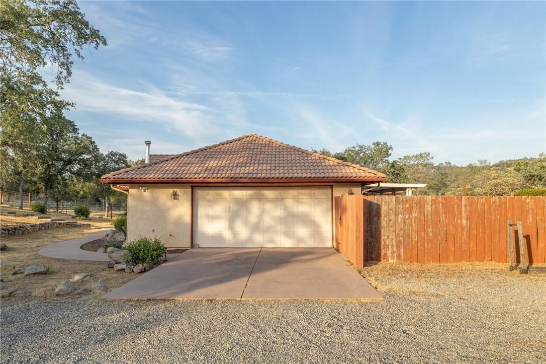 32057 River Knolls Road Coarsegold, CA 93614 - Photo 45 of 73 a view of a house with a yard