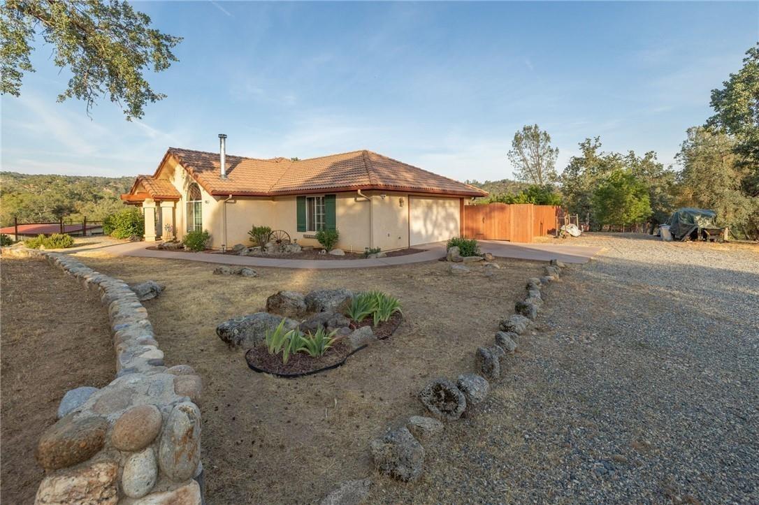 32057 River Knolls Road Coarsegold, CA 93614 - Photo 47 of 73 a view of a house with a yard and a garage