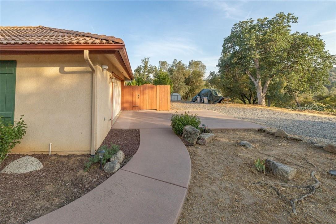32057 River Knolls Road Coarsegold, CA 93614 - Photo 48 of 73 a front view of a house with a yard and garage