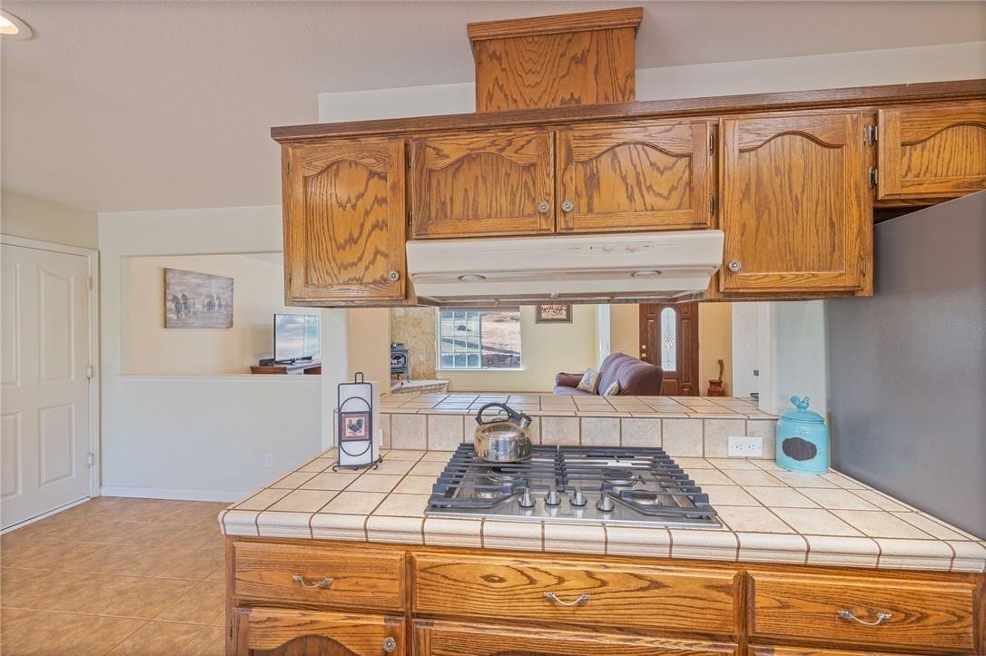 32057 River Knolls Road Coarsegold, CA 93614 - Photo 61 of 73 a kitchen with stainless steel appliances kitchen island granite countertop a sink and cabinets