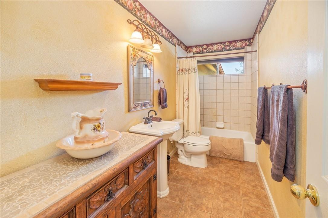 32057 River Knolls Road Coarsegold, CA 93614 - Photo 64 of 73 a bathroom with a granite countertop sink toilet and shower