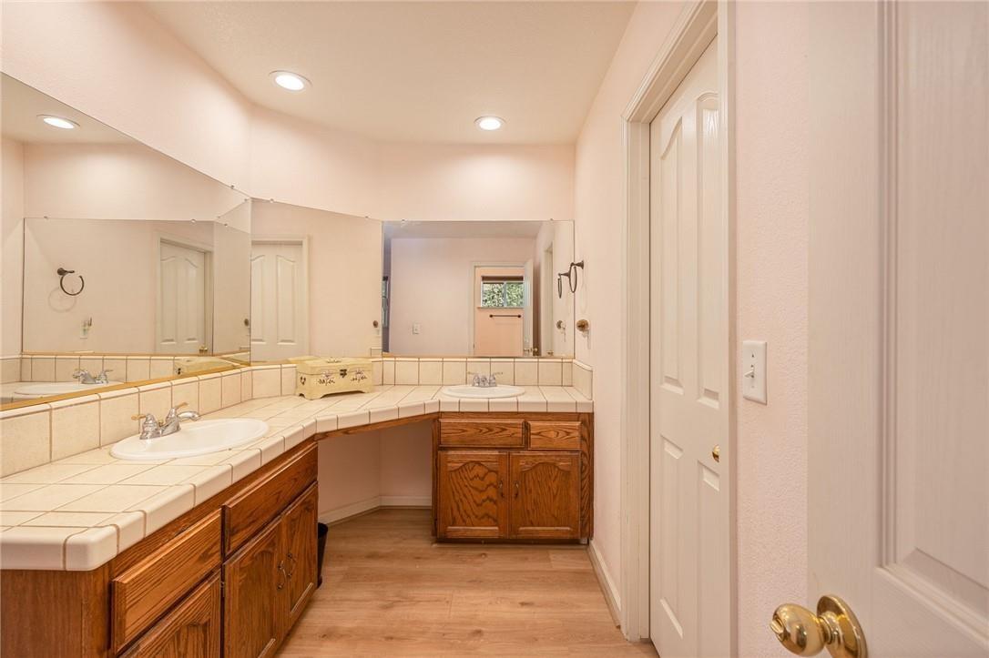 32057 River Knolls Road Coarsegold, CA 93614 - Photo 67 of 73 a bathroom with a double vanity sink mirror and double