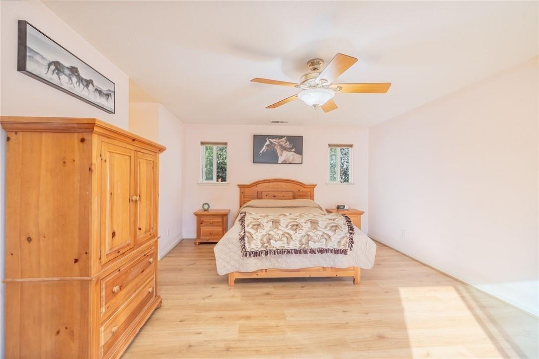 32057 River Knolls Road Coarsegold, CA 93614 - Photo 70 of 73 a bedroom with a bed and a chandelier