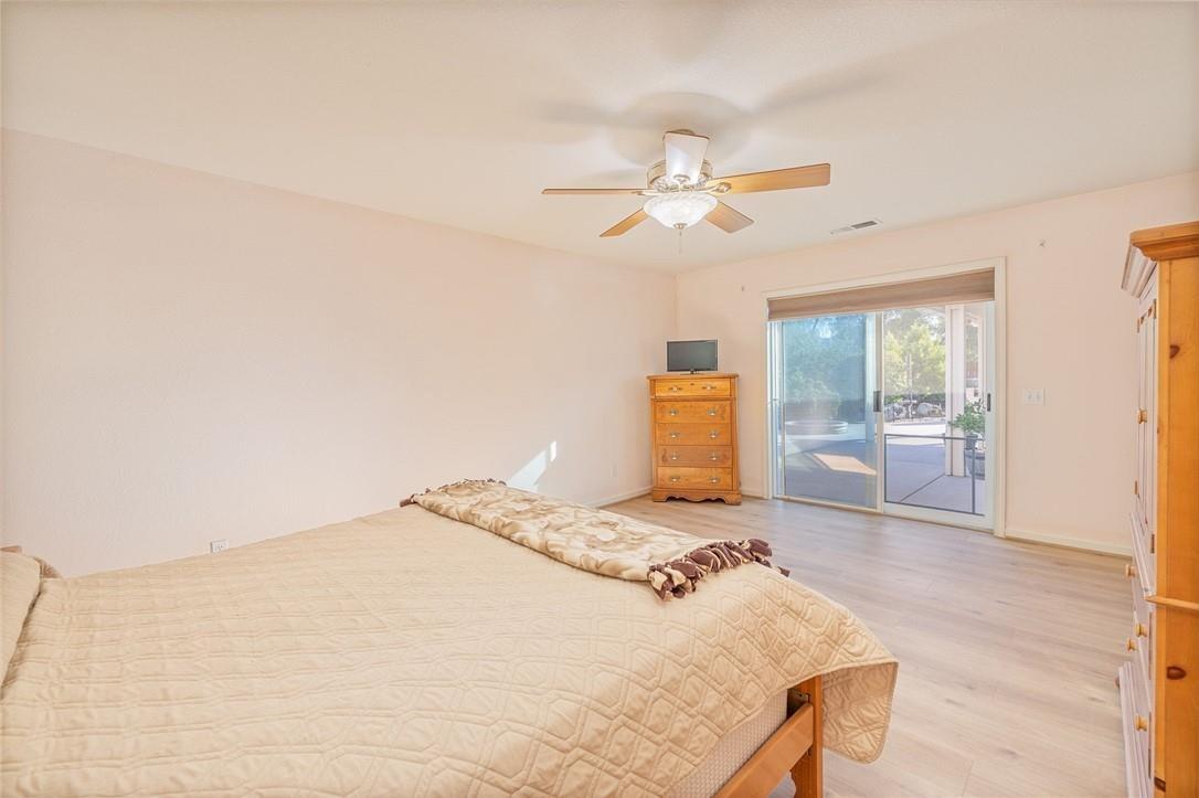32057 River Knolls Road Coarsegold, CA 93614 - Photo 71 of 73 a bedroom with a large bed a rug and ceiling fan