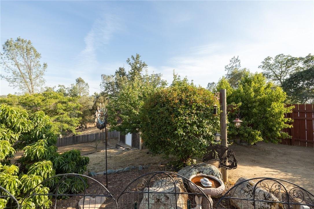 32057 River Knolls Road Coarsegold, CA 93614 - Photo 9 of 73 a couple of table and chairs in a backyard