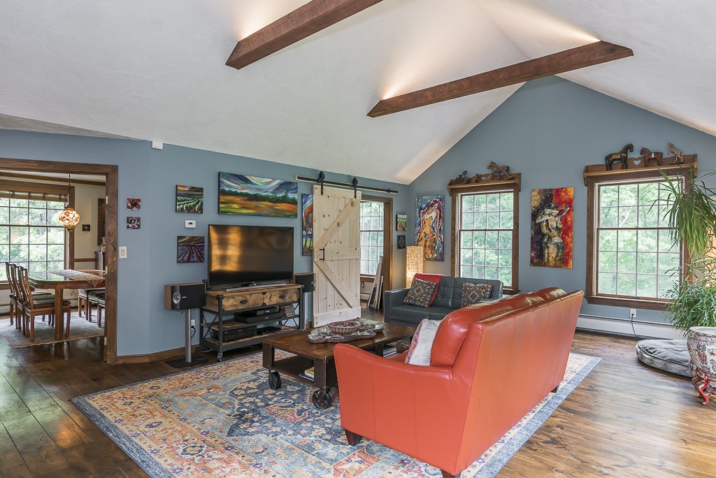 21 Pingree Farm Road Georgetown, MA 01833 - Photo 3 of 30 a living room with furniture and a flat screen tv with wooden floor