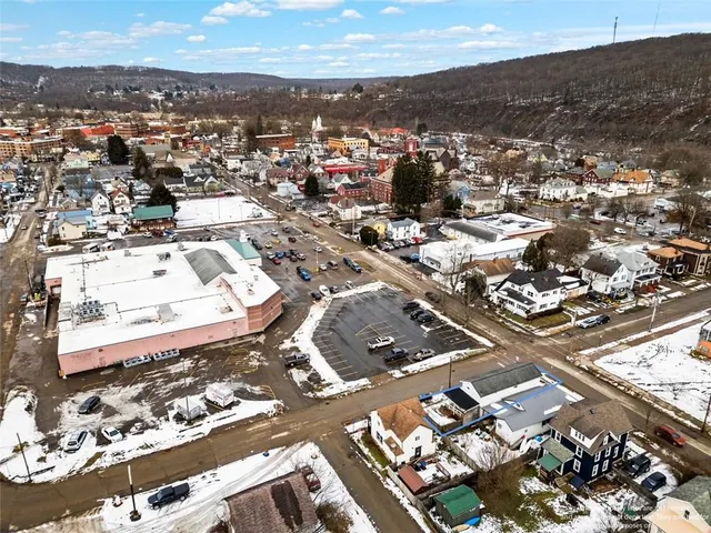 an aerial view of residential houses with city view