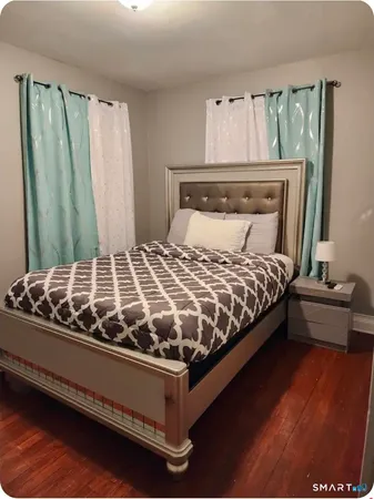 a bedroom with a bed and window